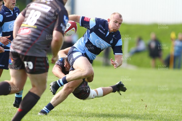 250818 - Cardiff Blues A v Scarlets A - Pre Season Friendly -  Dan Fish of Cardiff Blues A is tackled by Shaun Evans of Scarlets A 