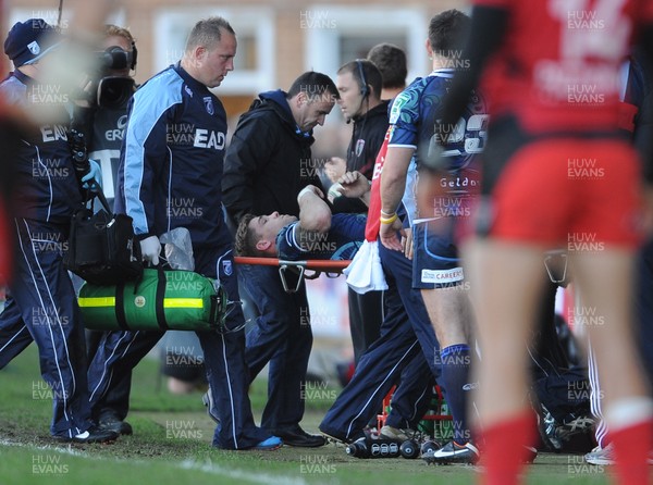 211012 - Cardiff Blues v Toulon - Heineken Cup -Gavin Evans of Cardiff Blues is helped off the field with an injury