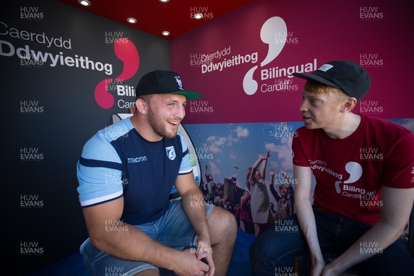 050818 - Cardiff Blues player Dillon Lewis chats with Dylan Hughes of Bilingual Cardiff at the Cardiff Council Stand at the National Eisteddfod to help announce an increased commitment by Cardiff Blues to the Welsh language as part of CardiffsBilingual Day