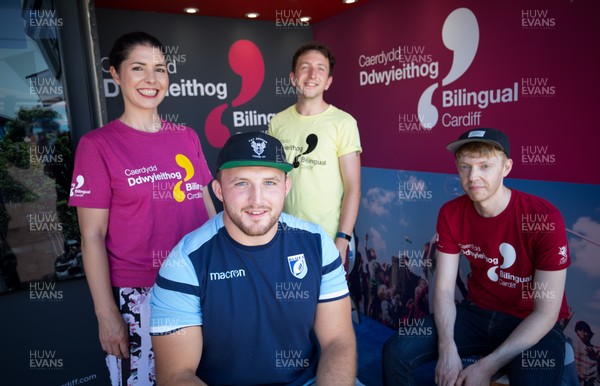 050818 - Cardiff Blues player Dillon Lewis with staff of Bilingual Cardiff at the Cardiff Council Stand at the National Eisteddfod to help announce an increased commitment by Cardiff Blues to the Welsh language as part of CardiffsBilingual Day Left to right, Ffion Gruffudd, James Eul and Dylan Hughes