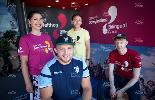 050818 - Cardiff Blues player Dillon Lewis with staff of Bilingual Cardiff at the Cardiff Council Stand at the National Eisteddfod to help announce an increased commitment by Cardiff Blues to the Welsh language as part of CardiffsBilingual Day Left to right, Ffion Gruffudd, James Eul and Dylan Hughes