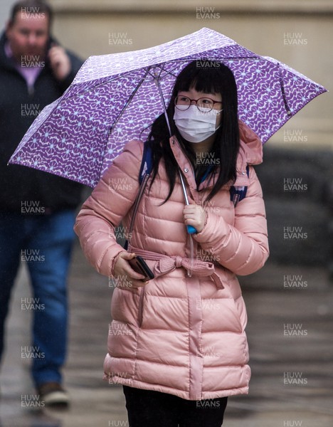 170320 - COVID-19 / Coronavirus - Picture shows a woman on Queens Street, Cardiff wearing a face mask