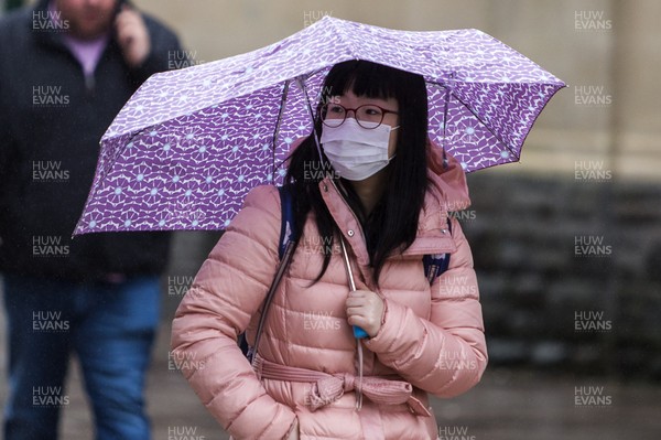170320 - COVID-19 / Coronavirus - Picture shows a woman on Queens Street, Cardiff wearing a face mask