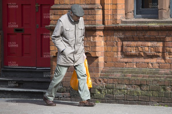 300320 - Cardiff City Centre Lockdown - An elderly man walks down Westgate Street, Cardiff during the coronavirus lockdown