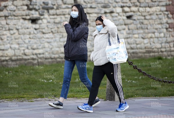 300320 - Cardiff City Centre Lockdown - Two women wearing masks as they walk down Castle Street, Cardiff during the coronavirus lockdown