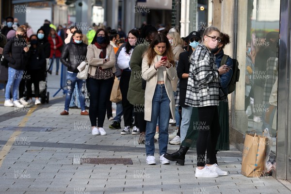 120421 - Picture shows shoppers outside Zara in Cardiff City Centre, Wales this morning on the first day non essential shops are allowed to be open since December 2020 during the coronavirus pandemic