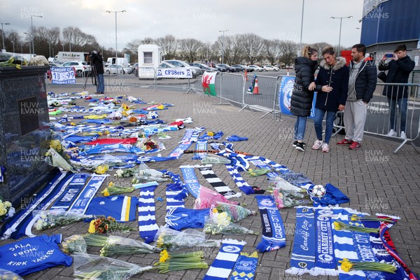 250119 - Picture shows the sister of footballer Emiliano Sala Romina consoled by cousin and partner as she looks on at all the tributes at Cardiff City Stadium for her brother, who was involved in a plane crash over the channel on Monday night