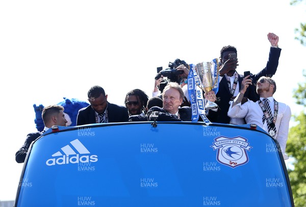 130518 - Cardiff City Open top bus tour to celebrate being promoted into the Premier League - Neil Warnock holds the trophy as they arrive in Cardiff Street