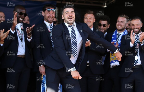 130518 - Cardiff City Open top bus tour to celebrate being promoted into the Premier League - Callum Paterson dances for the crowd