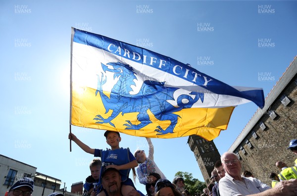 130518 - Cardiff City Open top bus tour to celebrate being promoted into the Premier League - Fans with Cardiff flag