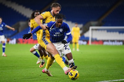 021225 -  Cardiff City v AFC Wimbledon - Vertu Trophy - Tanatswa Nyakuhwa of Cardiff City is challenged by Joe Lewis of Wimbledon