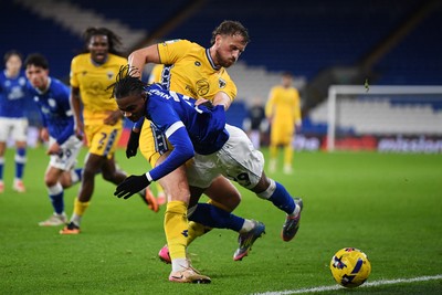 021225 -  Cardiff City v AFC Wimbledon - Vertu Trophy - Tanatswa Nyakuhwa of Cardiff City is challenged by Joe Lewis of Wimbledon