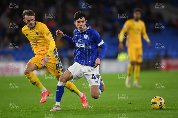 021225 -  Cardiff City v AFC Wimbledon - Vertu Trophy - Luey Giles of Cardiff City is challenged by Callum Maycock of Wimbledon