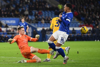 170226 - Cardiff City v AFC Wimbledon - Sky Bet League 1 - Nathan Bishop of Wimbledon clears the ball away from Chris Willock of Cardiff City