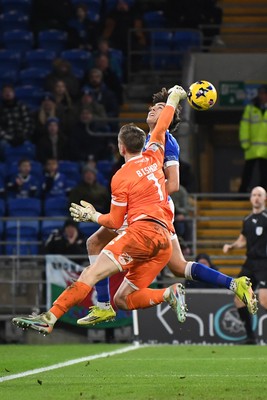 170226 - Cardiff City v AFC Wimbledon - Sky Bet League 1 - Nathan Bishop of Wimbledon attempts to punch the ball away but makes contact with Joel Colwill of Cardiff City