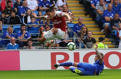 020918 - Cardiff City v Arsenal, Premier League - Hector Bellerin of Arsenal leaps out of the tackle from Joe Bennett of Cardiff City