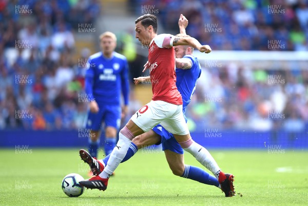 020918 - Cardiff City v Arsenal - Premier League - Mesut Ozil of Arsenal is tackled by Joe Ralls of Cardiff City