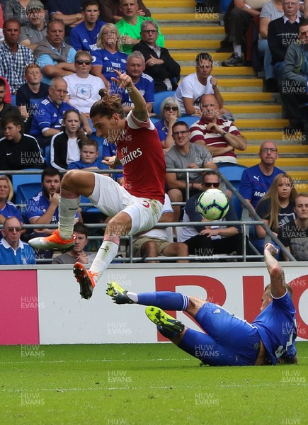 020918 - Cardiff City v Arsenal, Premier League - Hector Bellerin of Arsenal leaps out of the tackle from Joe Bennett of Cardiff City