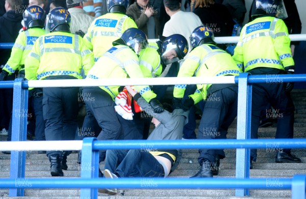 25.01.09 - Cardiff City v Arsenal - FA Cup - A Arsenal fan is lead away by police after trouble between fans at the end of the game. 