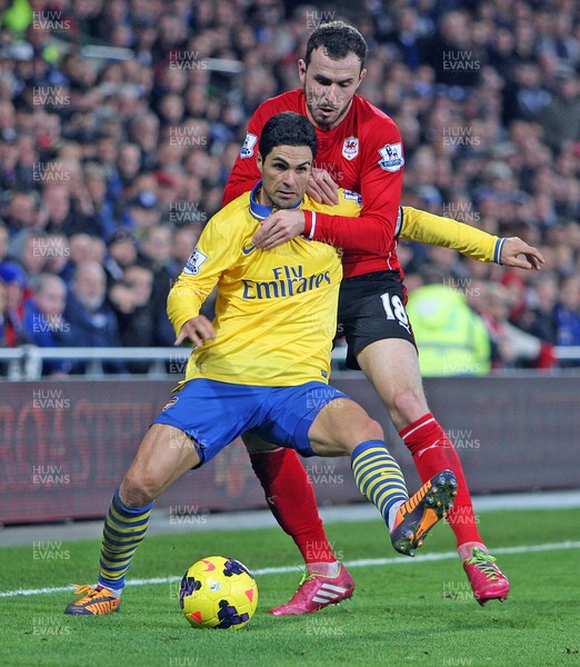 301113 - Cardiff City vs Arsenal - Barclays Premier League - Jordan Mutch of Cardiff gets to grips with Mikel Arteta of Arsenal(c) Huw Evans Agency