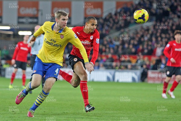 301113 - Cardiff City vs Arsenal - Barclays Premier League - Per Mertesaker of Arsenal and Peter Odemwingie of Cardiff(c) Huw Evans Agency