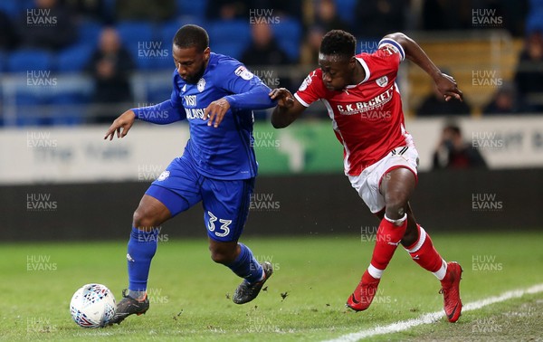 060318 - Cardiff City v Barnsley - SkyBet Championship - Junior Hoilett of Cardiff City is challenged by Andy Yiadom of Barnsley