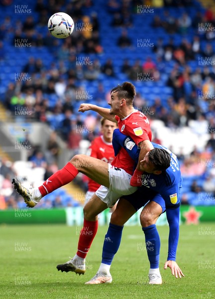 070821 - Cardiff City v Barnsley - Sky Bet EFL Championship - Liam Kitching of Barnsley is tackled by Kieffer Moore of Cardiff City
