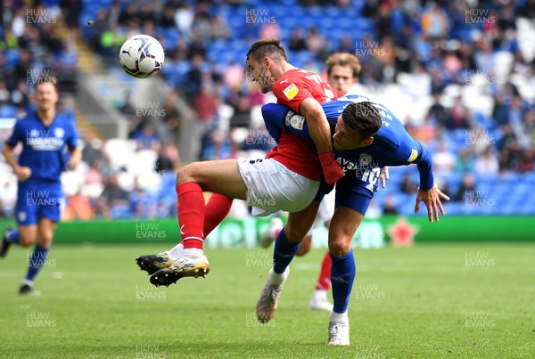 070821 - Cardiff City v Barnsley - Sky Bet EFL Championship - Liam Kitching of Barnsley is tackled by Kieffer Moore of Cardiff City