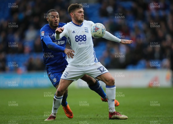 100318 - Cardiff City v Birmingham City, Sky Bet Championship - Kenneth Zohore of Cardiff City and Harlee Dean of Birmingham City compete for the ball