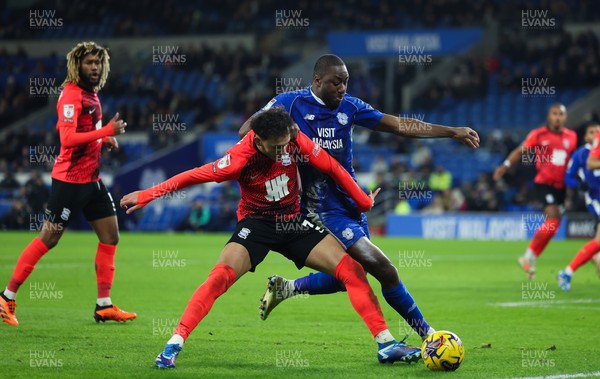 131223 - Cardiff City v Birmingham City, EFL Sky Bet Championship - Yakou Meite of Cardiff City and Lee Buchanan of Birmingham City tangle as they compete for the ball
