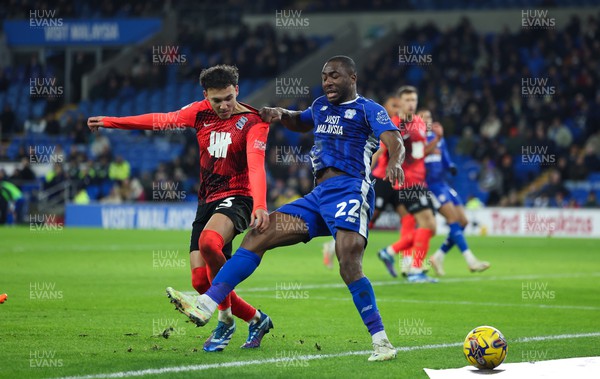 131223 - Cardiff City v Birmingham City, EFL Sky Bet Championship - Yakou Meite of Cardiff City and Lee Buchanan of Birmingham City tangle as they compete for the ball