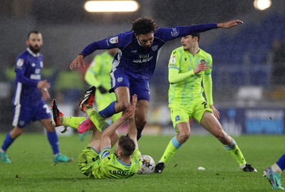 200224 - Cardiff City v Blackburn Rovers - SkyBet Championship - Kion Etete of Cardiff City trips over Dominic Hyam of Blackburn 