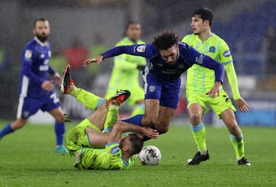 200224 - Cardiff City v Blackburn Rovers - SkyBet Championship - Kion Etete of Cardiff City trips over Dominic Hyam of Blackburn 