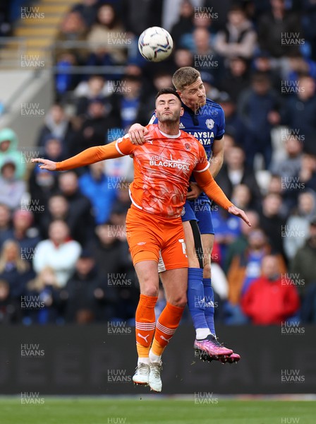 190222 - Cardiff City v Blackpool - SkyBet Championship - Gary Madine of Blackpool goes up for the ball with Mark McGuinness of Cardiff City