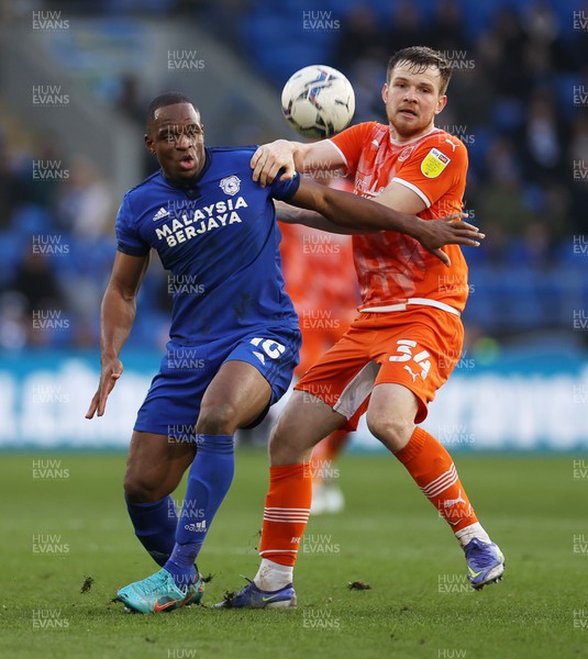 190222 - Cardiff City v Blackpool - SkyBet Championship - Uche Ikpeazu of Cardiff City is challenged by Jordan Thorniley of Blackpool