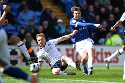 110426 - Cardiff City v Bolton Wanderers - Sky Bet League 1 - Ollie Tanner of Cardiff City has his shot blocked by Sam Dalby of Bolton