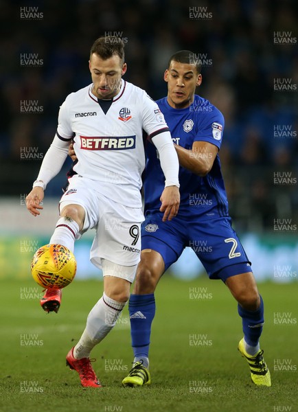 130218 - Cardiff City v Bolton Wanderers - SkyBet Championship - Adam Le Fondre of Bolton Wanderers is challenged by Lee Peltier of Cardiff City