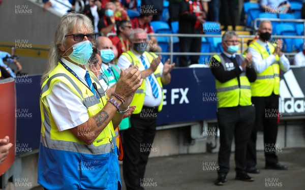 180921 - Cardiff City v Bournemouth, Sky Bet Championship - Cardiff City stewarding staff observe a round of applause in memory of fellow steward Dai Motherway who passed away recently