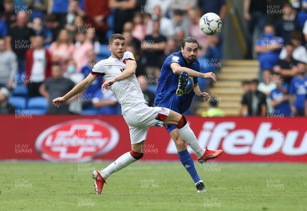 180921 - Cardiff City v Bournemouth, Sky Bet Championship - Ciaron Brown of Cardiff City plays the ball forward as Ryan Christie of Bournemouth closes in