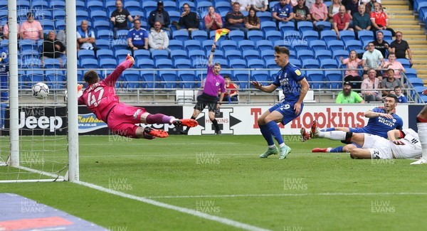 180921 - Cardiff City v Bournemouth, Sky Bet Championship - Bournemouth goalkeeper Mark Travers dives for the ball as Mark Harris of Cardiff City looks for the shot at goal