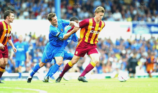 160803 - Cardiff City v Bradford City - Division One - Bradford's Simon Francis shrugs off Wiilie Boland's tackle