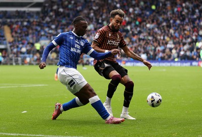 200925 - Cardiff City v Bradford City - SkyBet League One - Ronan Kpakio of Cardiff City is challenged by Tyreik Wright of Bradford City 