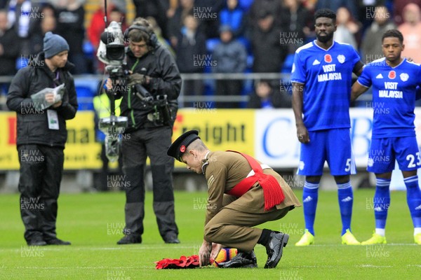101118 - Cardiff City v Brighton & Hove Albion, Premier League - A member of the Armed Forces lays a wreath of poppies on the centre spot in Remembrance