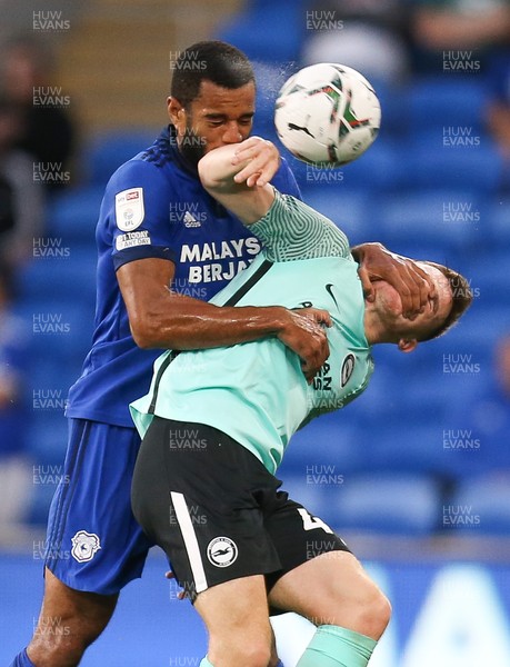 240821 - Cardiff City v Brighton and Hove Albion, EFL Carabao Cup - Curtis Nelson of Cardiff City and Marc Leonard of Brighton tangle as they compete for the ball