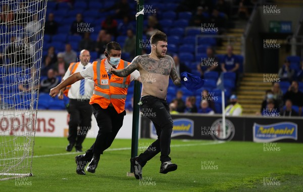 240821 - Cardiff City v Brighton and Hove Albion, EFL Carabao Cup - A third Cardiff City fan invades the pitch and tries to return to the crowd