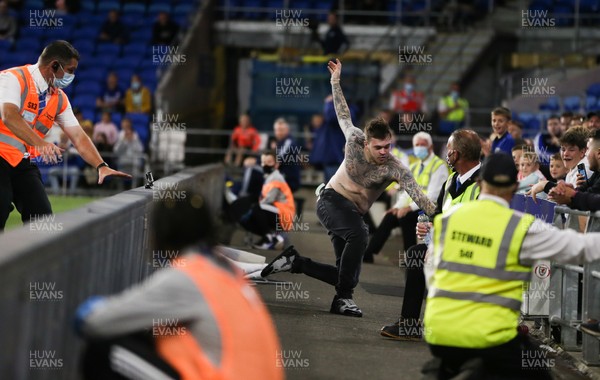 240821 - Cardiff City v Brighton and Hove Albion, EFL Carabao Cup - A third Cardiff City fan invades the pitch and tries to return to the crowd