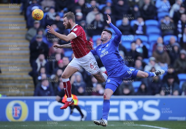 250218 - Cardiff City v Bristol City, Sky Bet Championship - Nathan Baker of Bristol City and Gary Madine of Cardiff City compete for the ball