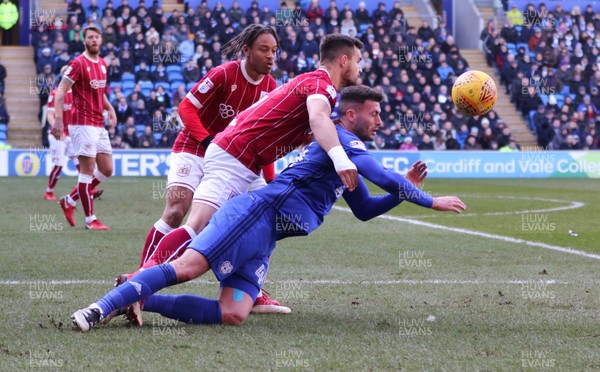 250218 - Cardiff City v Bristol City, Sky Bet Championship - Gary Madine of Cardiff City is brought down by Bailey Wright of Bristol City