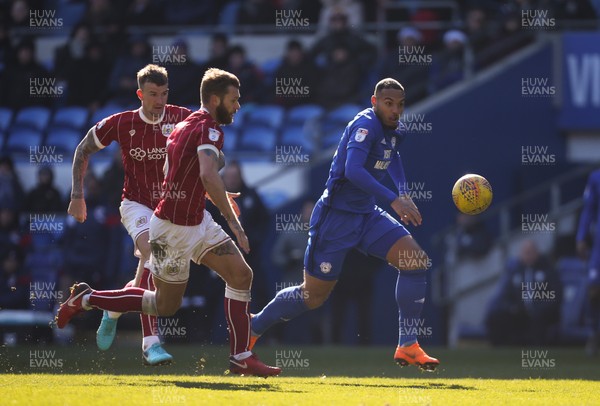 250218 - Cardiff City v Bristol City, Sky Bet Championship - Kenneth Zohore of Cardiff City and Aden Flint of Bristol City look to win the ball