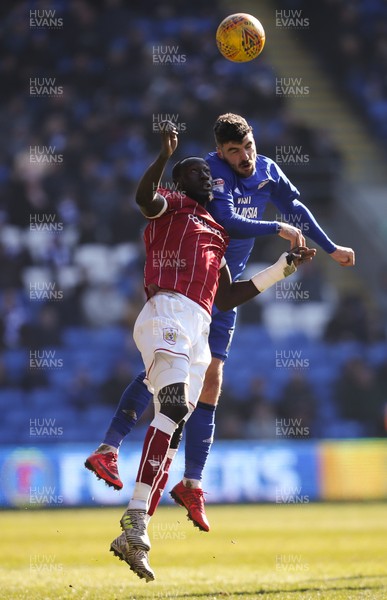 250218 - Cardiff City v Bristol City, Sky Bet Championship - Callum Paterson of Cardiff City and Famara Diedhiou of Bristol City compete for the ball